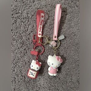 Two Hello Kitty Keychains with key rings and strap